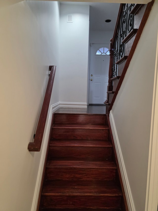 stairs featuring baseboards and wood finished floors