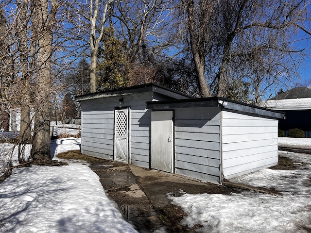 snow covered structure with an outdoor structure