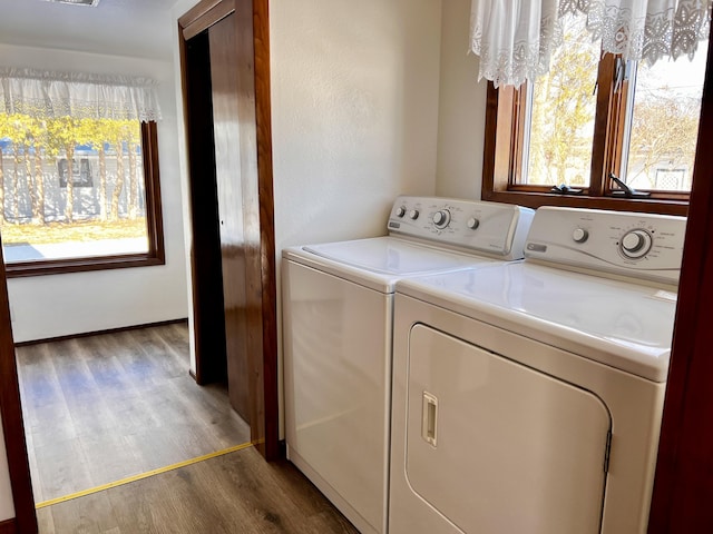 washroom with laundry area, visible vents, independent washer and dryer, and wood finished floors