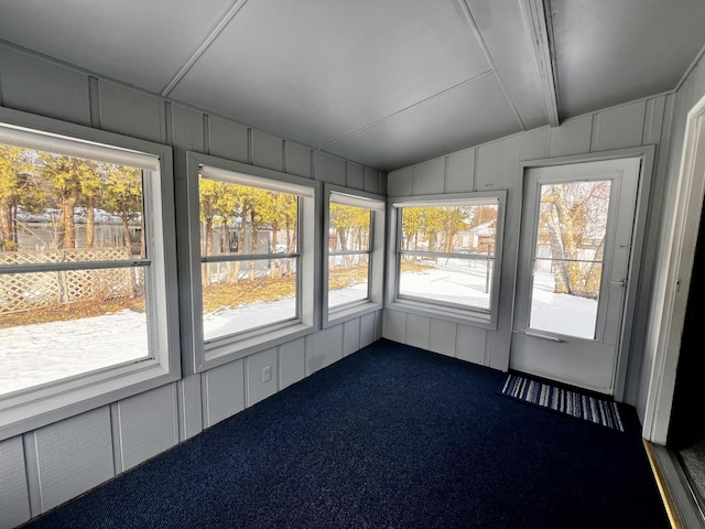 unfurnished sunroom featuring lofted ceiling