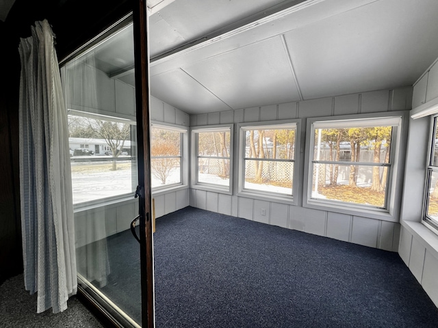 unfurnished sunroom featuring lofted ceiling