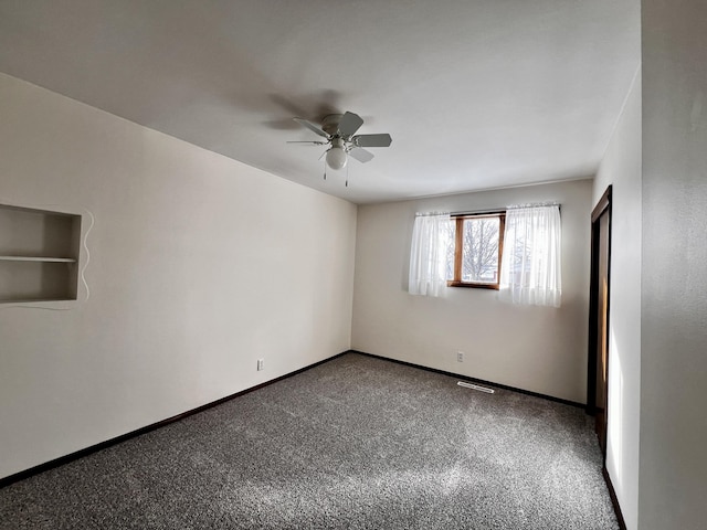 unfurnished room with visible vents, carpet flooring, a ceiling fan, and baseboards