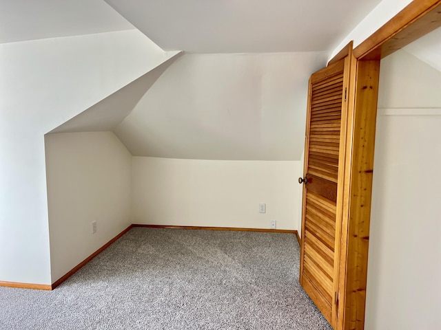 bonus room featuring carpet floors, vaulted ceiling, and baseboards