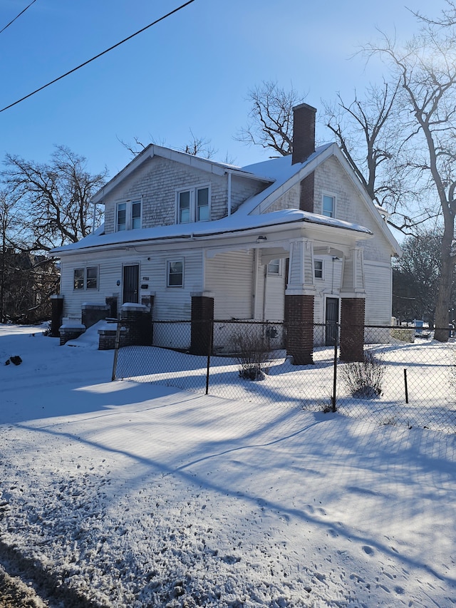 exterior space featuring a porch, a chimney, and fence