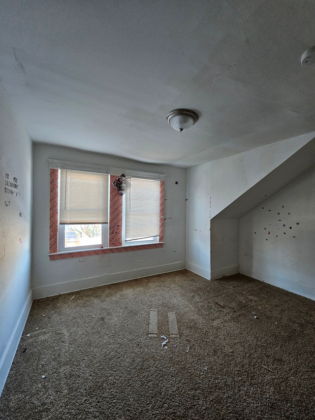 additional living space featuring carpet floors and baseboards