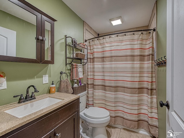 bathroom featuring toilet and vanity