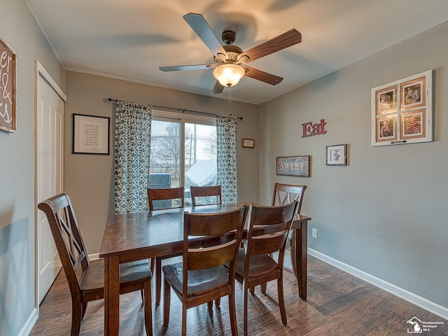 dining area featuring baseboards, dark wood finished floors, and a ceiling fan