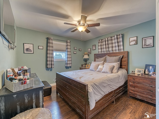 bedroom featuring baseboards, dark wood finished floors, and a ceiling fan