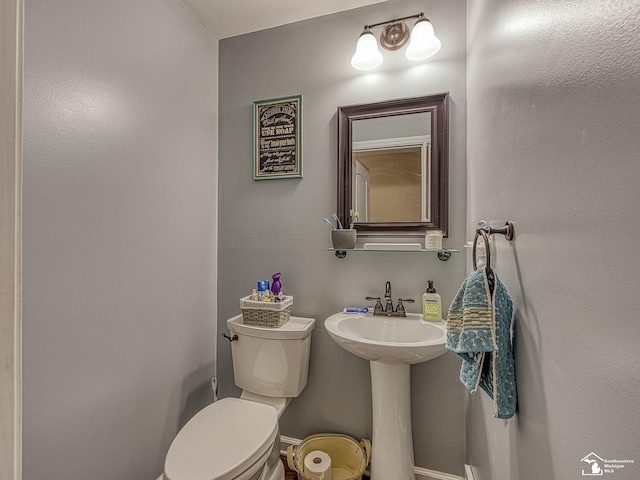 bathroom featuring toilet and a sink