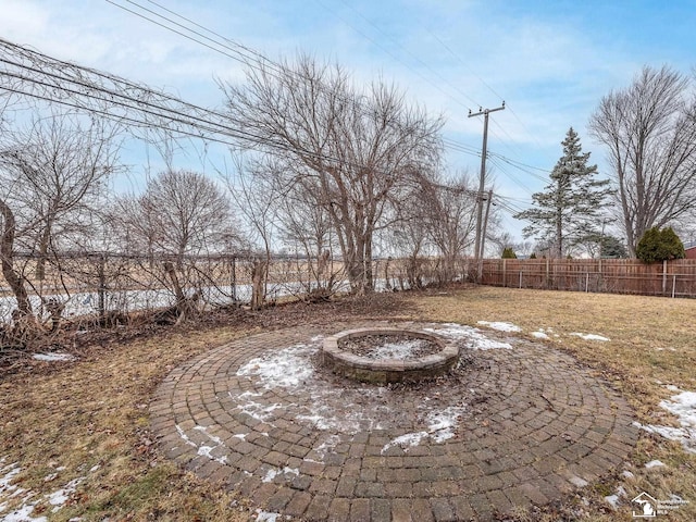 view of yard featuring an outdoor fire pit and fence