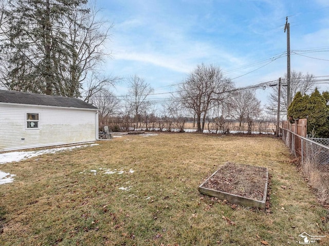 view of yard with fence and a vegetable garden