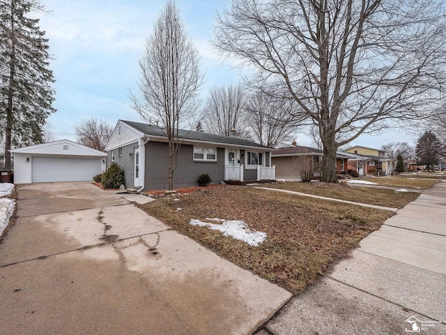 single story home with a garage, brick siding, covered porch, and an outbuilding