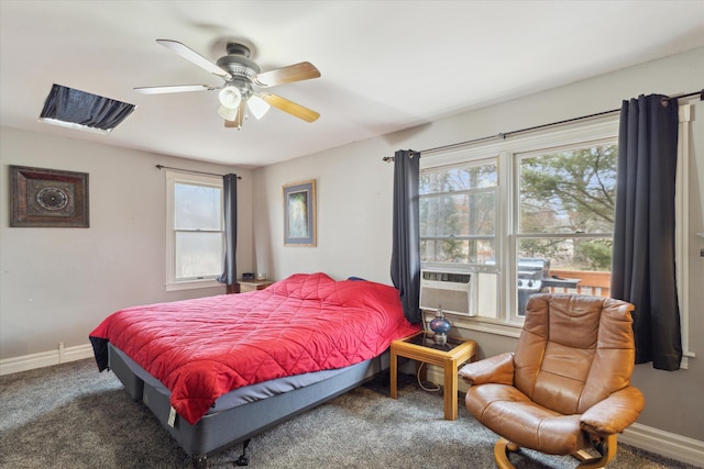 carpeted bedroom with cooling unit, multiple windows, and baseboards