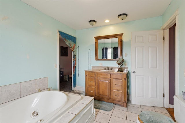 full bathroom featuring tile patterned flooring, vanity, and a tub with jets