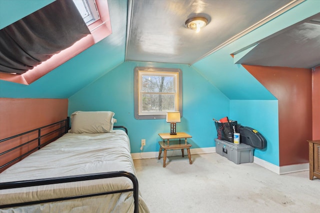 carpeted bedroom with lofted ceiling and baseboards