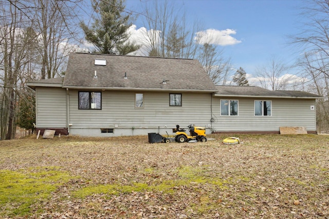 back of property featuring a shingled roof