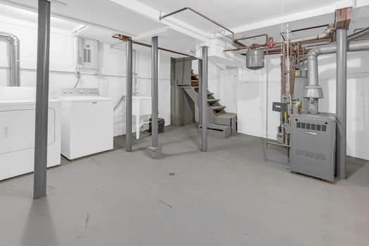 unfinished basement with washer and clothes dryer and stairs