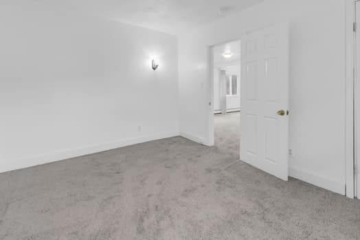 empty room with carpet floors and baseboards