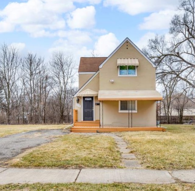 view of front of home with a front lawn and stucco siding