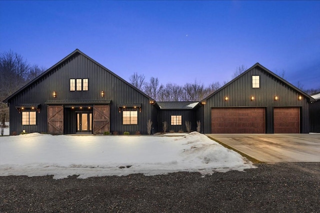 view of front of property with board and batten siding, concrete driveway, and an attached garage