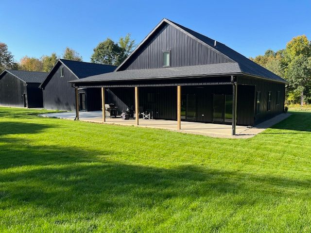 rear view of house with a patio and a yard