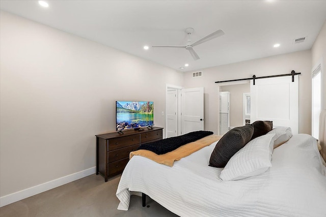 bedroom with a barn door, baseboards, a ceiling fan, ensuite bathroom, and recessed lighting