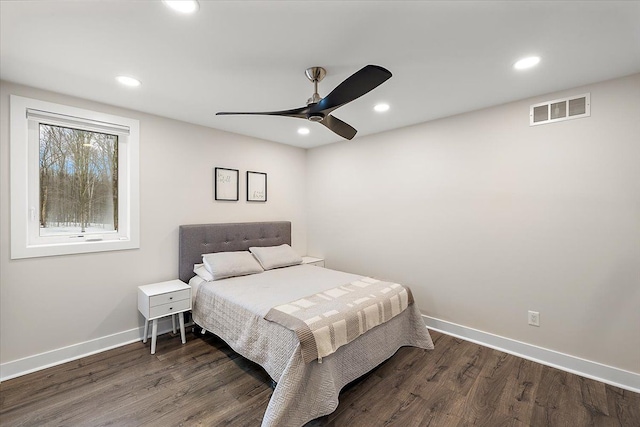 bedroom with baseboards, visible vents, wood finished floors, and recessed lighting