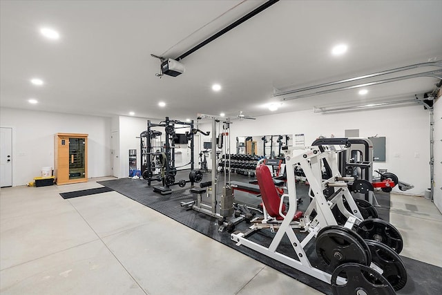 workout area featuring a garage and recessed lighting