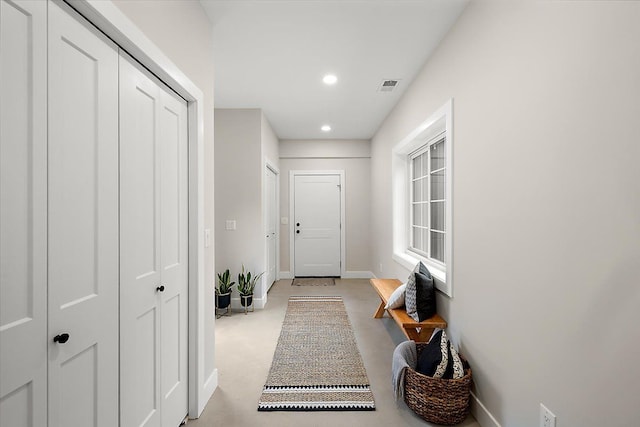 entryway with baseboards, visible vents, and recessed lighting