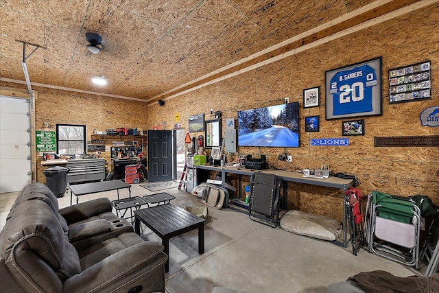 living area with concrete flooring, a garage, and a workshop area