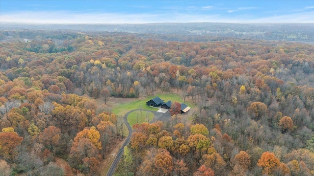 drone / aerial view featuring a forest view