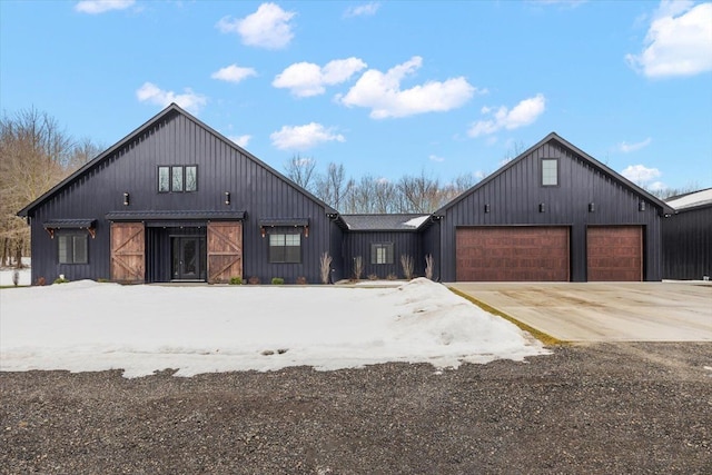 modern farmhouse featuring a garage and concrete driveway