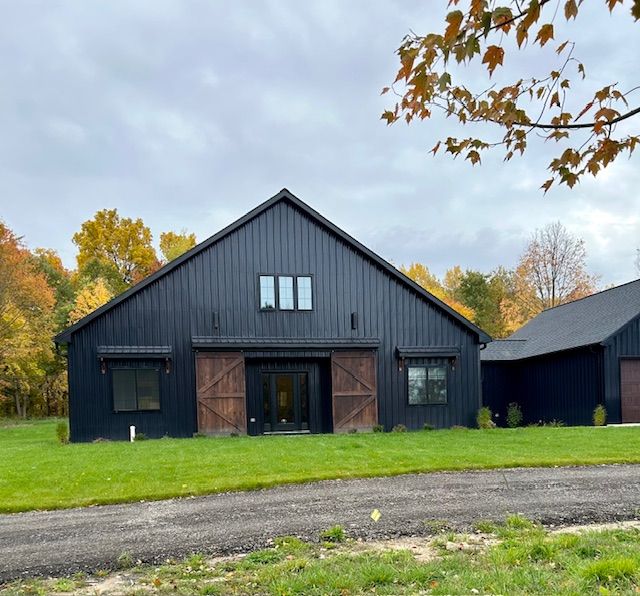 view of barn with a garage and a yard