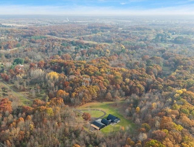 birds eye view of property with a wooded view