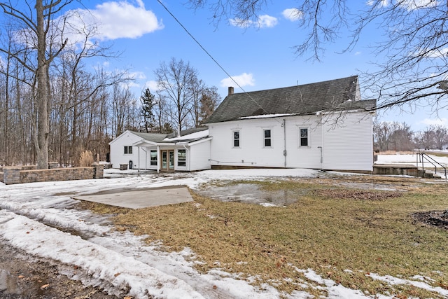 snow covered house with a chimney