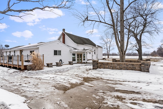 snow covered property with a wooden deck