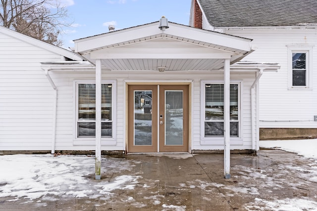 view of snow covered property entrance