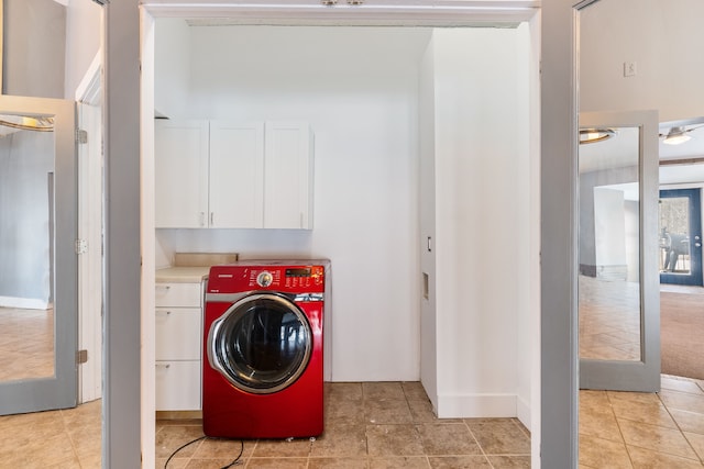 laundry area with washer / clothes dryer, cabinet space, and light tile patterned floors