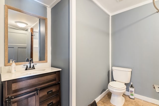 bathroom with toilet, tile patterned flooring, baseboards, and vanity