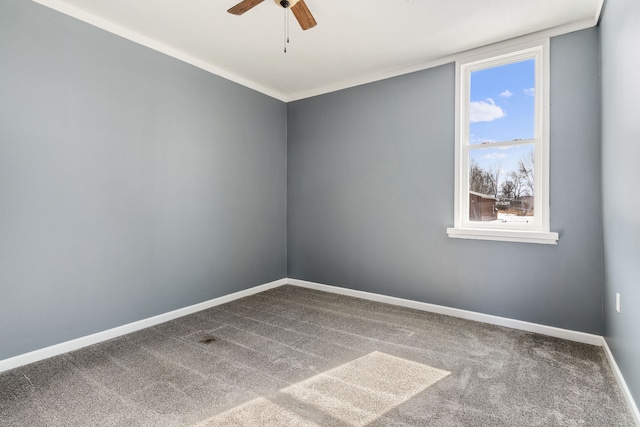 unfurnished room featuring a ceiling fan, carpet flooring, and baseboards