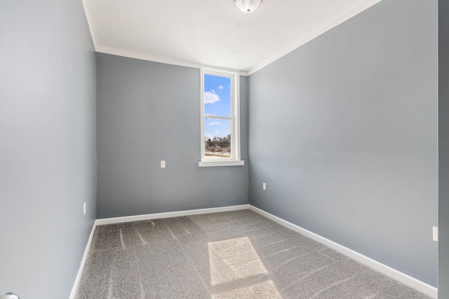 carpeted empty room featuring baseboards