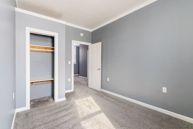 unfurnished bedroom featuring baseboards, ornamental molding, a closet, and light colored carpet