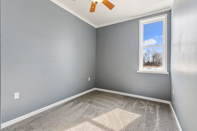 carpeted empty room featuring crown molding, baseboards, and a ceiling fan