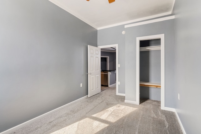 unfurnished bedroom featuring light carpet, baseboards, a closet, and ornamental molding