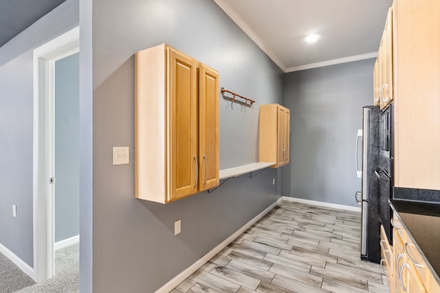 interior space with light wood-type flooring, baseboards, and ornamental molding