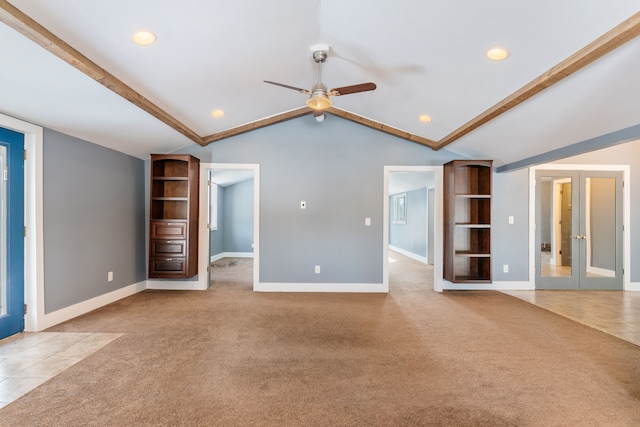 unfurnished living room featuring light colored carpet, baseboards, vaulted ceiling, and french doors