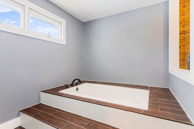 bathroom featuring a bathing tub and wood finish floors