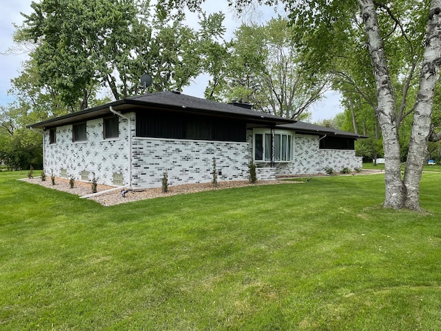 rear view of house featuring a yard