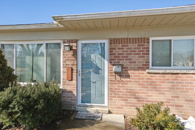 property entrance with brick siding