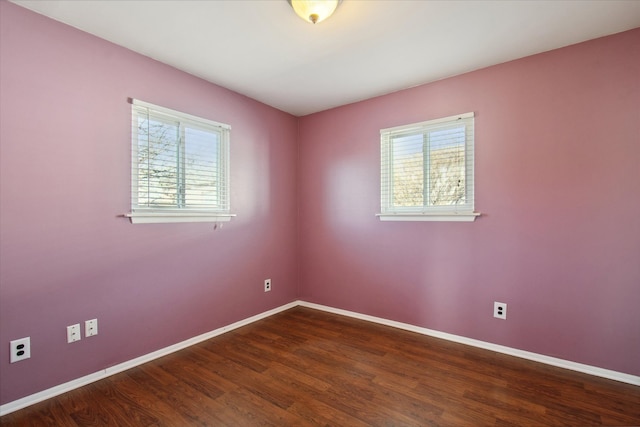 empty room with baseboards and wood finished floors